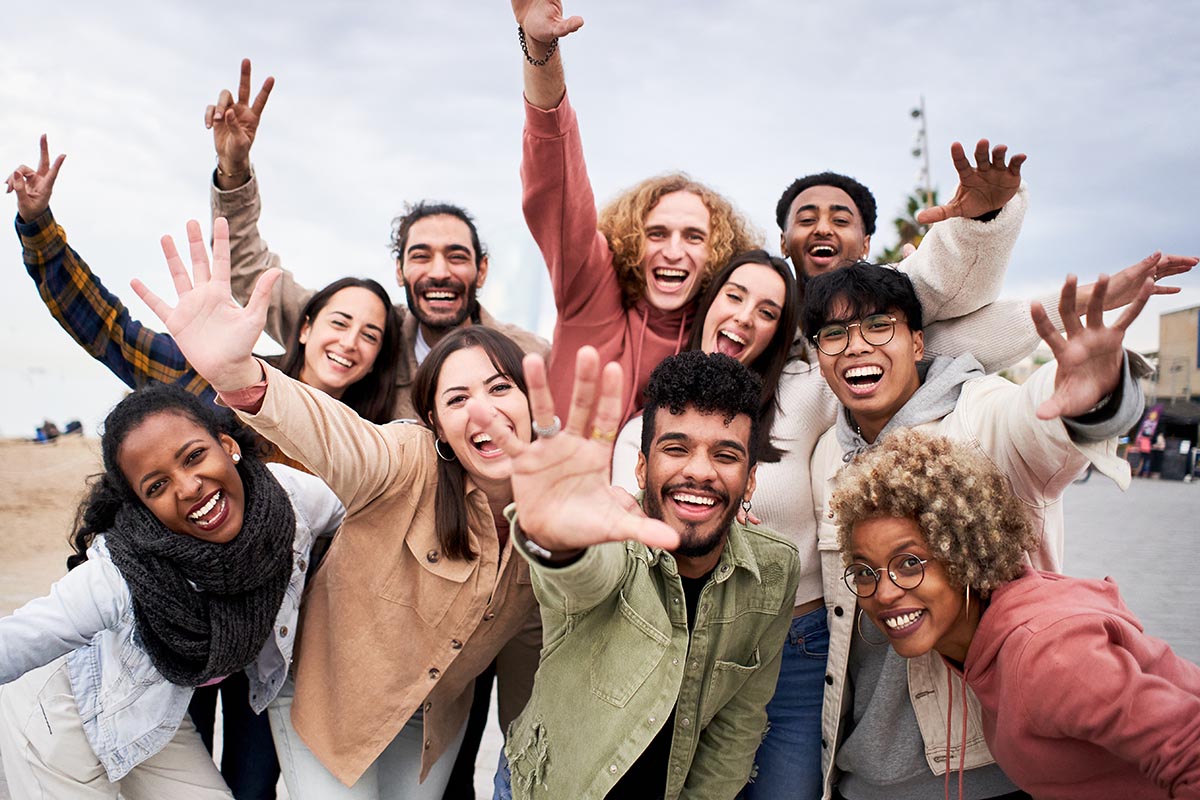Big group of cheerful young friends taking selfie portrait. Happy people looking at the camera smiling. Concept of community, youth lifestyle and friendship. High quality photo